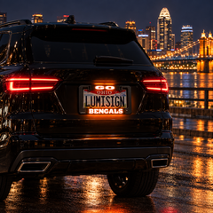 Illuminated GO Ohio Lumisign Bengals license plate frame on SUV rear, nighttime