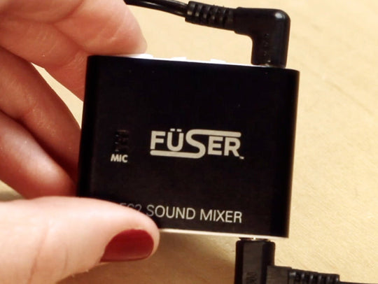 Handheld FÜSER sound mixer box with connected power cable