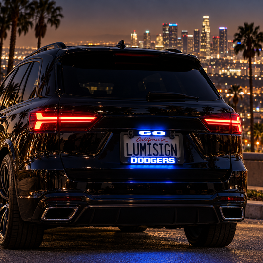 Car rear with glowing LED license plate frame reading "LUMISIGN DODGERS"