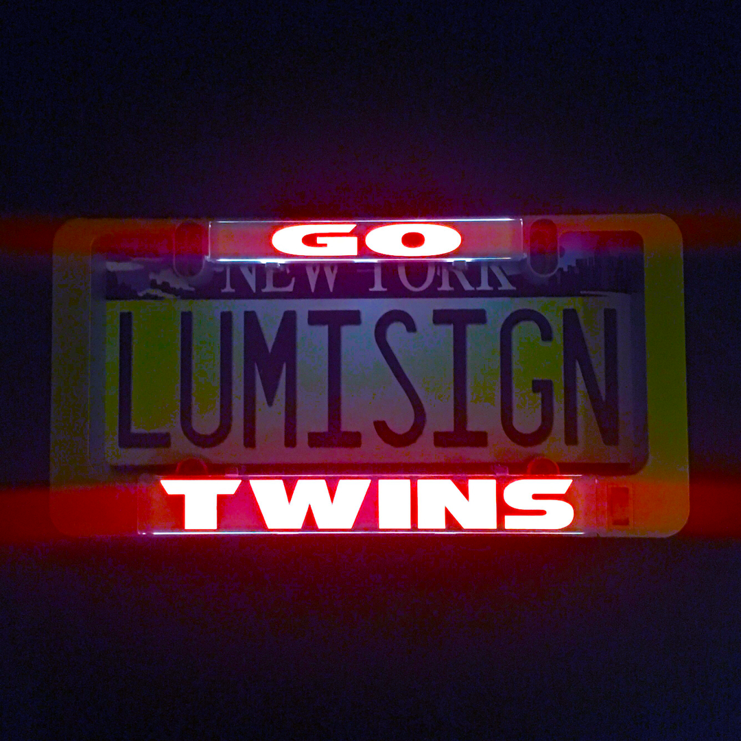 GO TWINS illuminated sign insert with glowing GO and TWINS text over Lumisign lettering