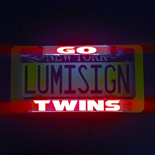 GO TWINS illuminated sign insert with glowing GO and TWINS text over Lumisign lettering