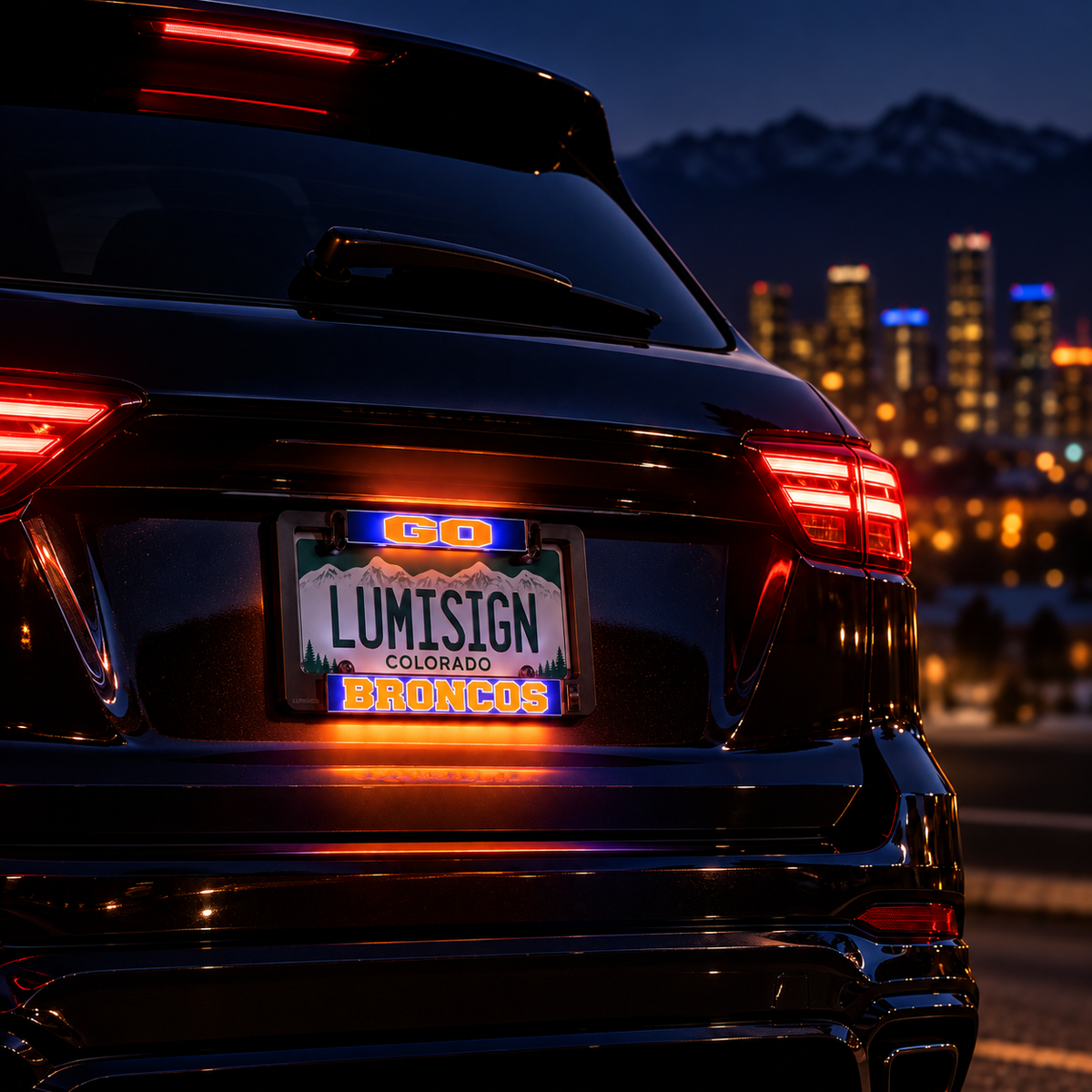 Lumisign LED license plate frame on car with glowing Go, Broncos, and state text