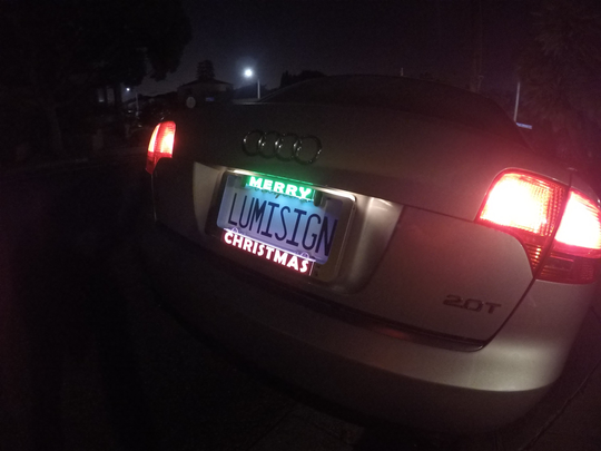 LumiSign Christmas insert glowing on a vehicle license plate area.