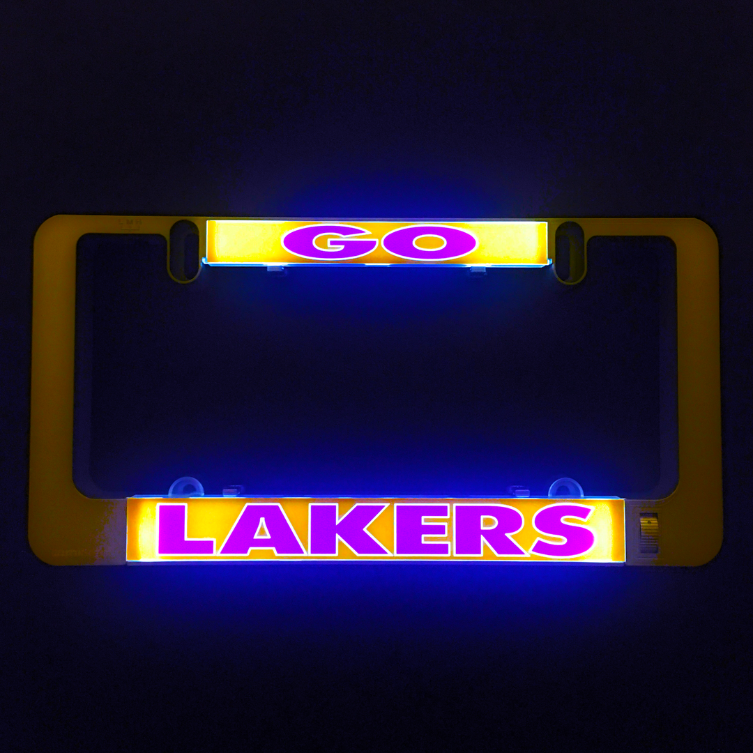Black license plate frame with LAKERS light-up insert, glowing gold and purple LEDs.