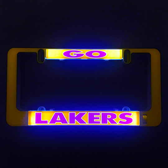 Black license plate frame with LAKERS light-up insert, glowing gold and purple LEDs.