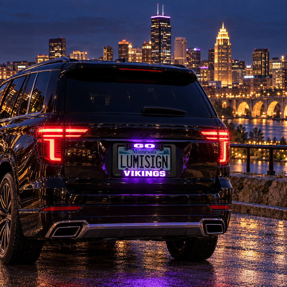 Black car license plate frame with illuminated VIKINGS LED lettering