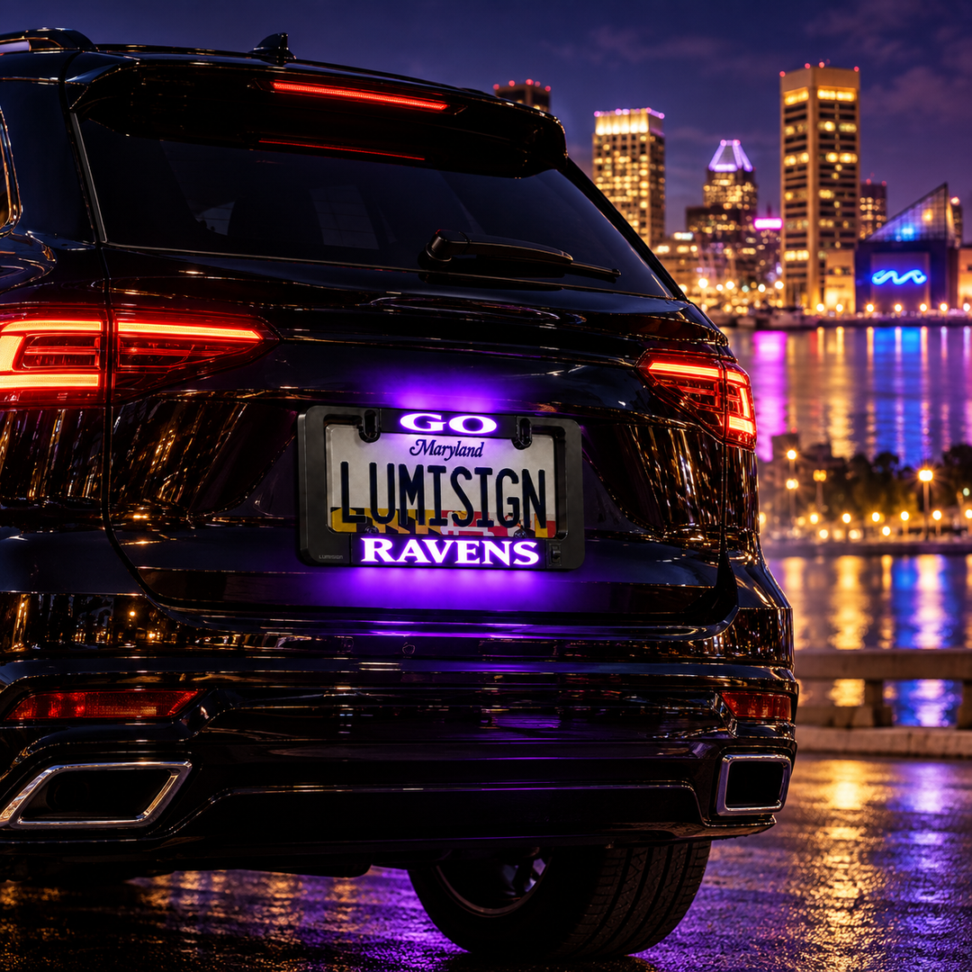 Car rear license plate frame with glowing LUMISIGN RAVENS lights