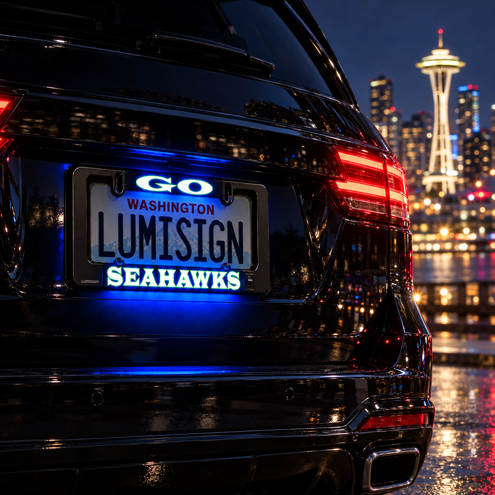 Glowing LED license plate frame on a car rear, displaying Washington and Seahawks