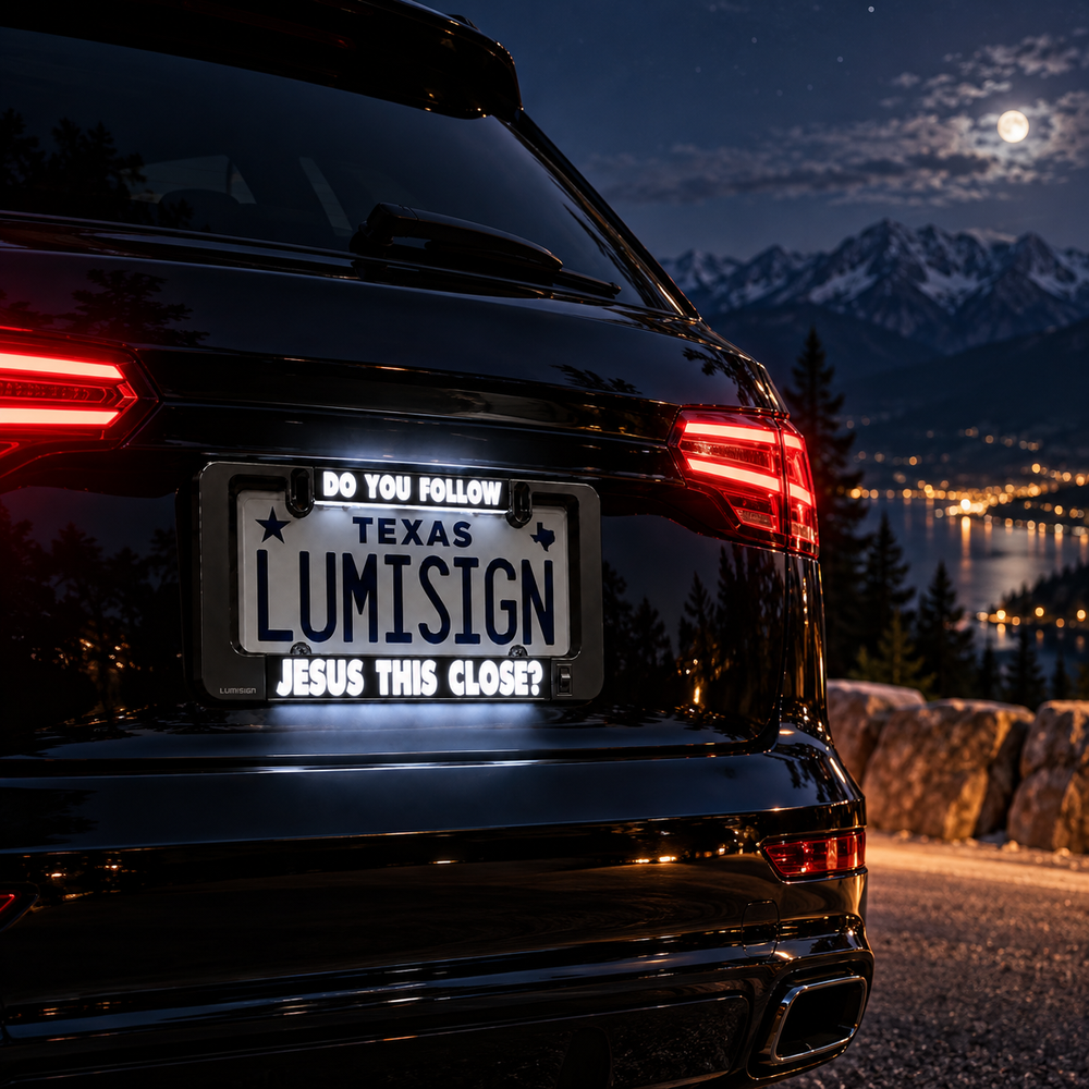 Car license plate frame with “TEXAS LUMISIGN” and “JESUS THIS CLOSE?”