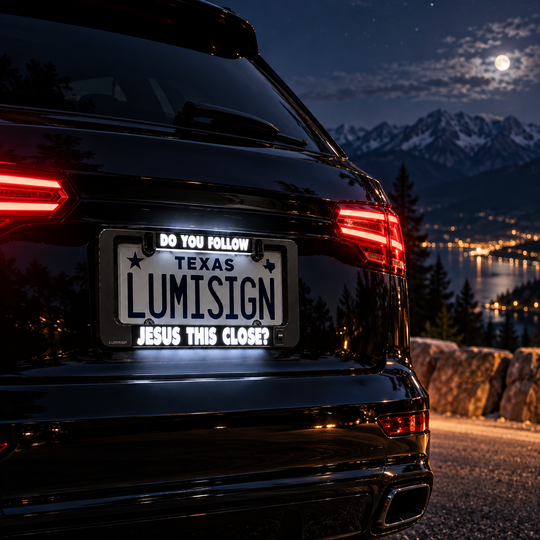 Car license plate frame with “TEXAS LUMISIGN” and “JESUS THIS CLOSE?”