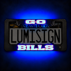 Close-up black license plate frame reading “LUMISIGN BILLS” with blue/red light