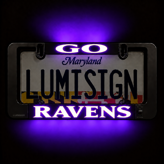 Close-up of illuminated license plate frame reading Maryland LUMISIGN RAVENS