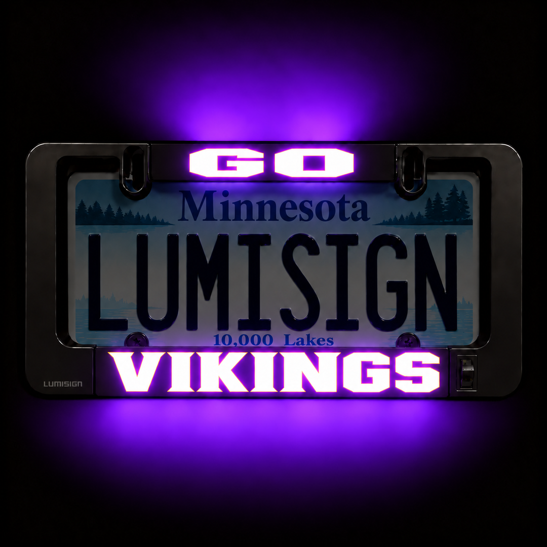 Black license plate frame with purple-lit LUMISIGN and VIKINGS graphic