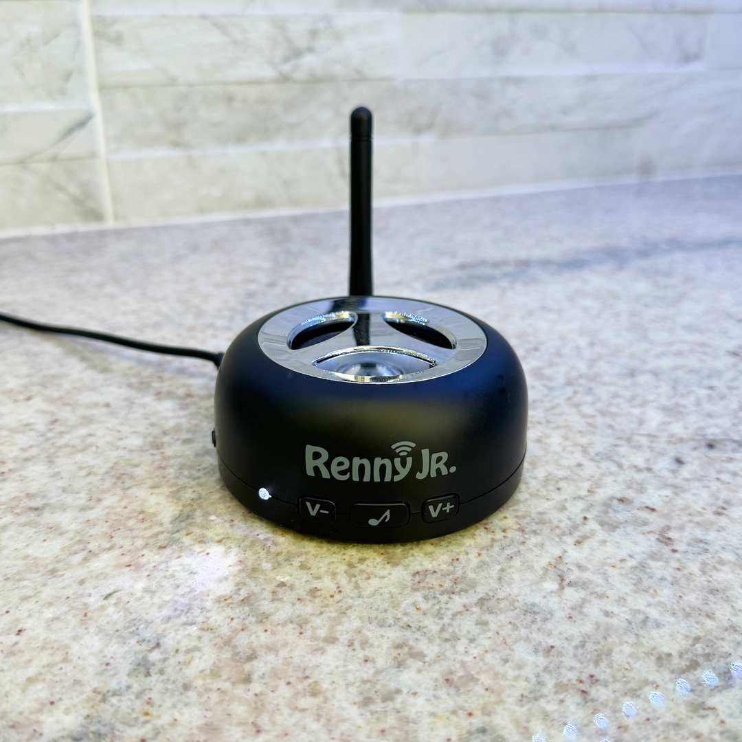 Loud cell phone ringer with vertical antenna and top speaker dial, on tabletop