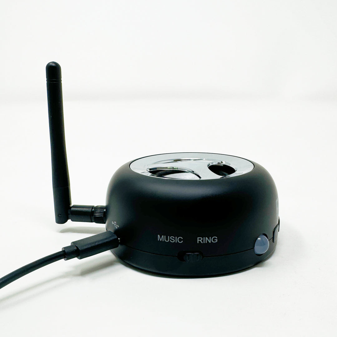 Loud cell phone ringer with side antenna and labeled buttons on the base