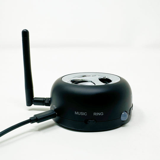 Loud cell phone ringer with side antenna and labeled buttons on the base