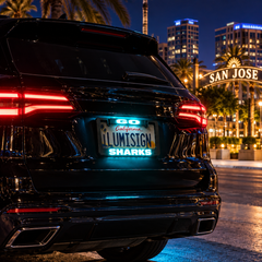 Car rear with illuminated LUMISIGN California SHARKS license plate frame